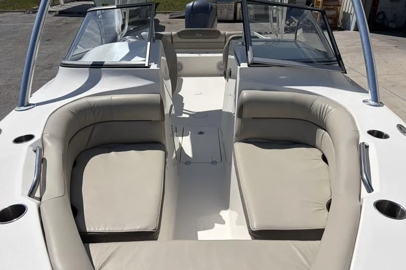 Slide: The Image of 2023 Key West 239 DFS boat interior with beige seating and dual consoles. - 7