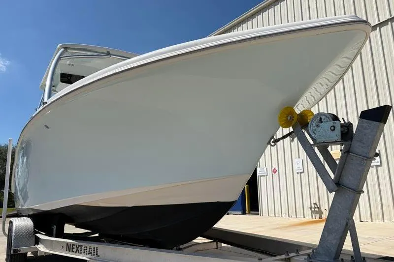 Slide: The Image of 2023 Key West 239 DFS boat on trailer, parked outside a warehouse. - 8