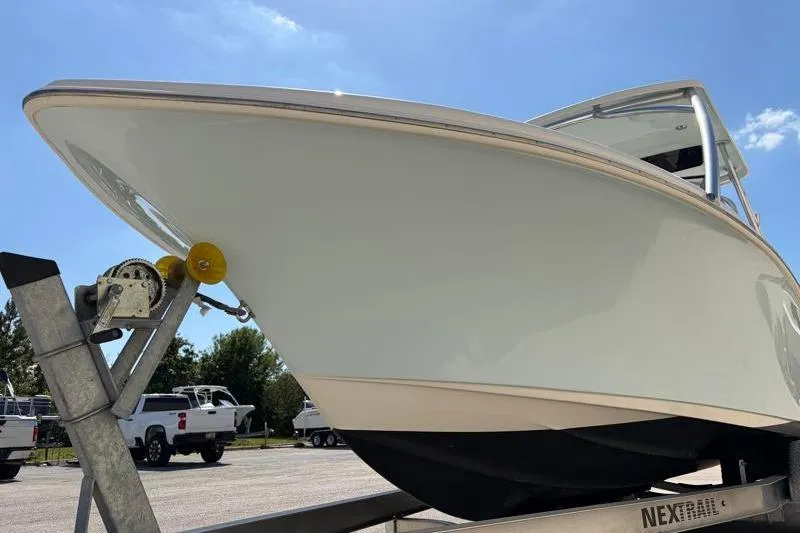 Slide: The Image of 2023 Key West 239 DFS boat on trailer under clear blue sky. - 9