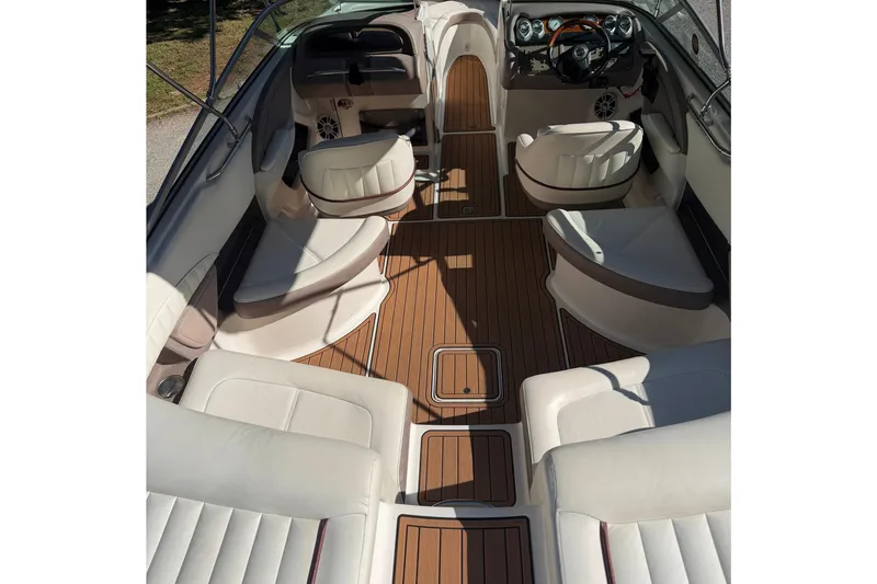 Slide: The Image of Interior of a 2004 Cobalt 250 boat with luxurious seating and wood flooring. - 11