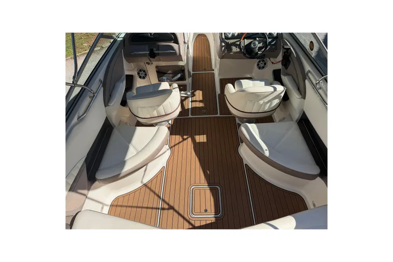 Slide: The Image of Interior of a 2004 Cobalt 250 boat with white seating and wood flooring. - 12