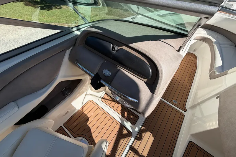Slide: The Image of 2004 Cobalt 250 boat interior with wood flooring and cushioned seating. - 15