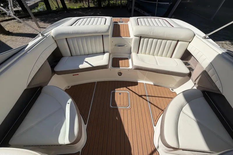 Slide: The Image of 2004 Cobalt 250 boat interior with white leather seating and teak flooring. - 17