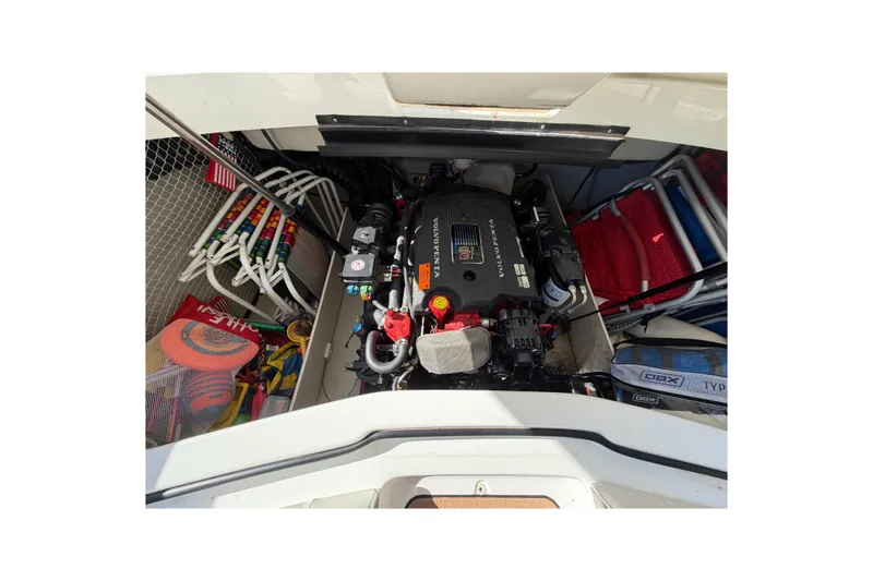 Slide: The Image of Engine compartment of a 2004 Cobalt 250 boat with organized storage items. - 28