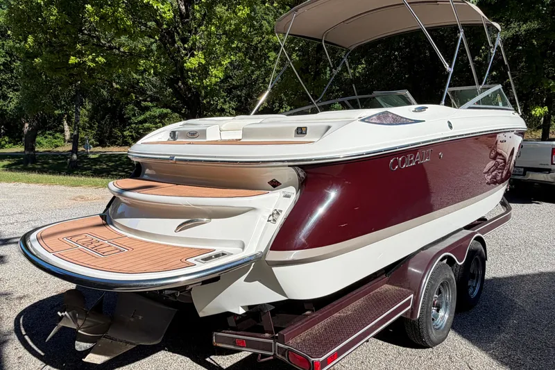 Slide: The Image of Boat trailer for 2004 Cobalt 250 on gravel, near a marina. - 30
