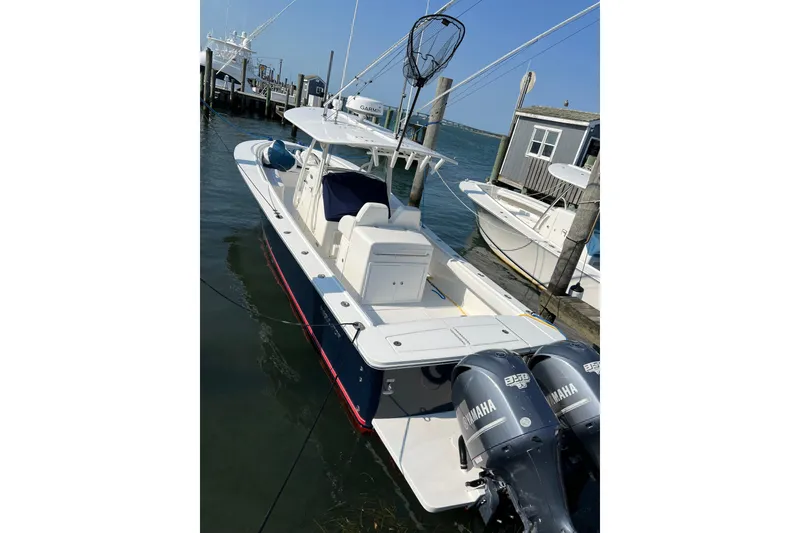 The Image of 2015 Regulator 34SS boat docked with twin Yamaha engines. - 0
