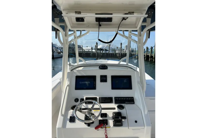 Slide: The Image of 2015 Regulator 34SS boat helm with Garmin navigation system and steering wheel. - 1