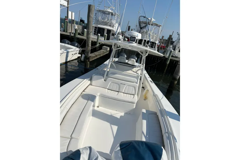 Slide: The Image of 2015 Regulator 34SS boat docked at marina, featuring spacious seating and sleek design. - 2