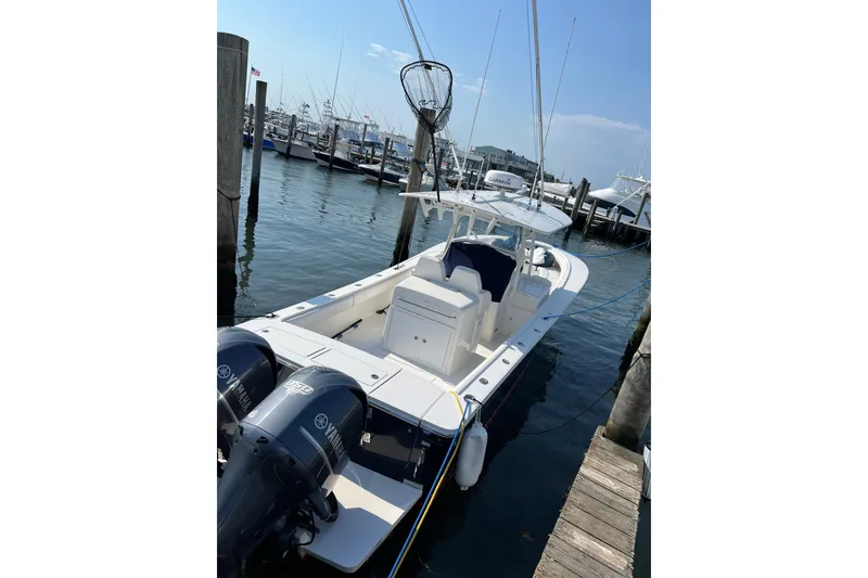 Slide: The Image of 2015 Regulator 34SS boat docked, featuring dual Yamaha engines and spacious deck. - 3