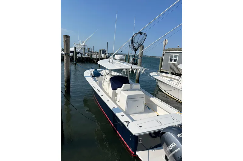 Slide: The Image of 2015 Regulator 34SS boat docked at marina with Yamaha engine. - 8