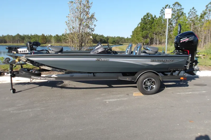 The Image of 2024 Ranger RT188P fishing boat on trailer, parked outdoors near a lake. - 0