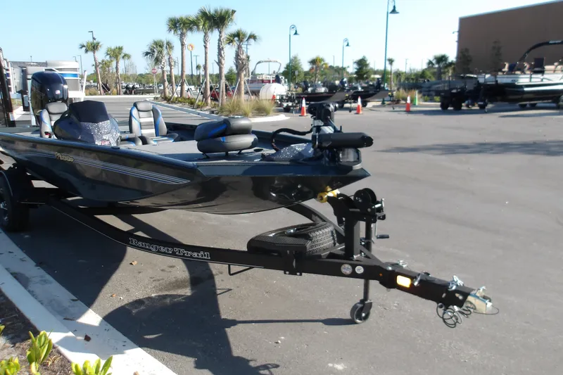 Slide: The Image of 2024 Ranger RT188P boat on trailer in sunny outdoor setting. - 2