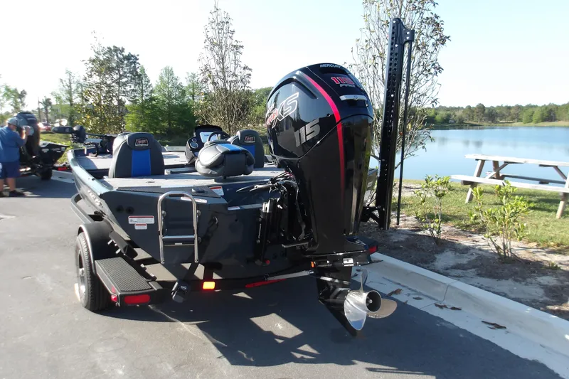Slide: The Image of 2024 Ranger RT188P boat with Mercury 115 engine, parked near a scenic lake. - 9