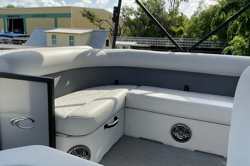 Slide: The Image of Interior of 2026 Crest Conquest SE 220 Cruise boat with white seating and speaker. - 10