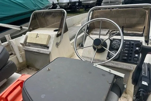Slide: The Image of 1990 Wahoo 16.5 boat interior with steering wheel and control panel. - 5