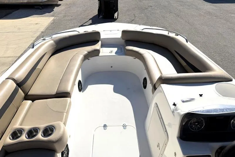 Slide: The Image of 2022 Hurricane SunDeck Sport 201 OB boat interior with beige seating and cup holders. - 10