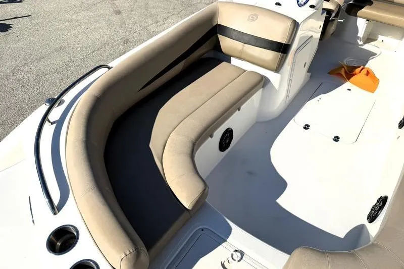 Slide: The Image of 2022 Hurricane SunDeck Sport 201 OB boat interior with beige seating and storage compartments. - 12