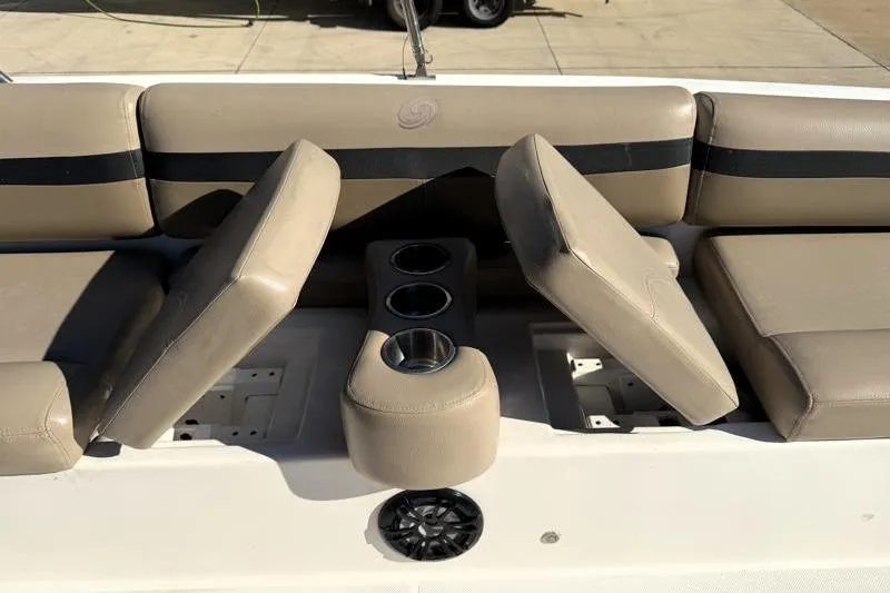 Slide: The Image of 2022 Hurricane SunDeck Sport 201 OB boat interior with beige seating and cup holders. - 16