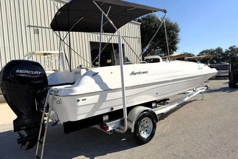 Slide: The Image of 2022 Hurricane SunDeck Sport 201 OB boat with Mercury engine on trailer. - 2