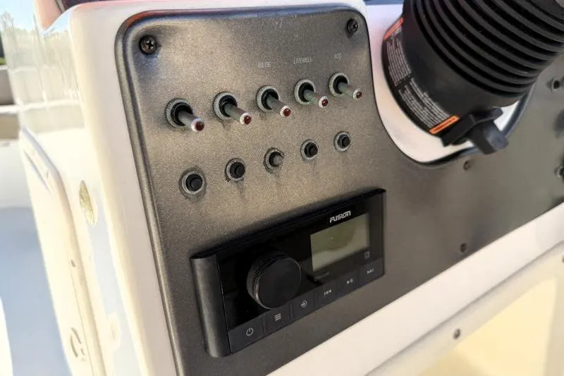 Slide: The Image of Control panel of 2022 Hurricane SunDeck Sport 201 OB boat with switches and audio system. - 21