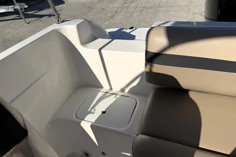 Slide: The Image of 2022 Hurricane SunDeck Sport 201 OB boat interior with beige seating and storage compartment. - 23
