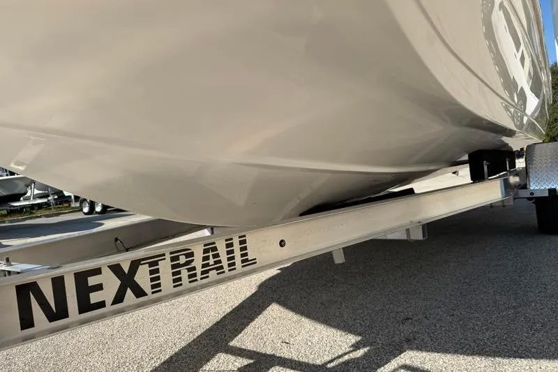 Slide: The Image of 2022 Hurricane SunDeck Sport 201 OB boat on NexTrail trailer, side view. - 26