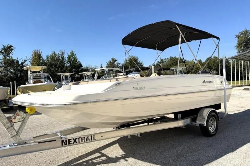 Slide: The Image of 2022 Hurricane SunDeck Sport 201 OB boat on trailer, featuring a black canopy. - 3