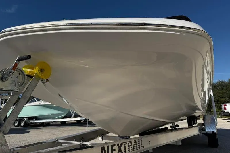 Slide: The Image of 2022 Hurricane SunDeck Sport 201 OB boat on trailer, viewed from the front. - 8