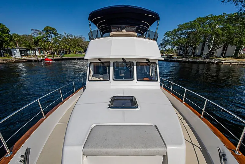 Slide: The Image of 2013 Grand Banks 43 Europa yacht on calm water, showcasing sleek design and spacious deck. - 14