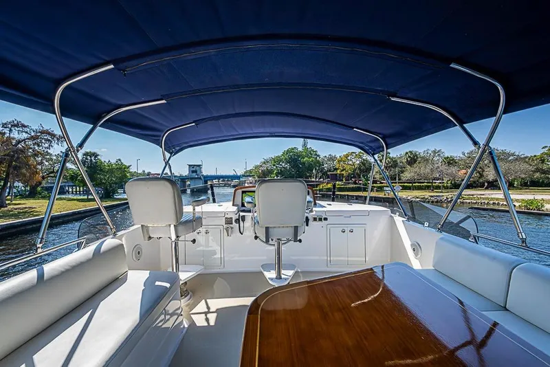 Slide: The Image of 2013 Grand Banks 43 Europa yacht interior with blue canopy and scenic waterway view. - 18