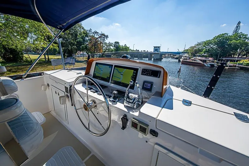 Slide: The Image of Helm of 2013 Grand Banks 43 Europa yacht with navigation screens and steering wheel. - 19