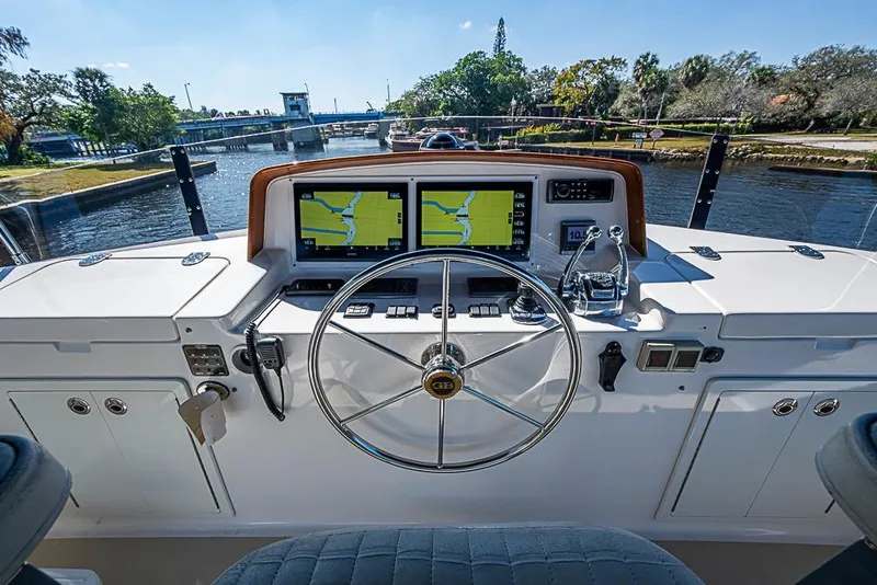 Slide: The Image of Helm of 2013 Grand Banks 43 Europa yacht with navigation screens and steering wheel. - 20