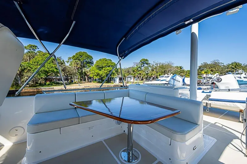 Slide: The Image of 2013 Grand Banks 43 Europa yacht with shaded outdoor seating and table. - 23