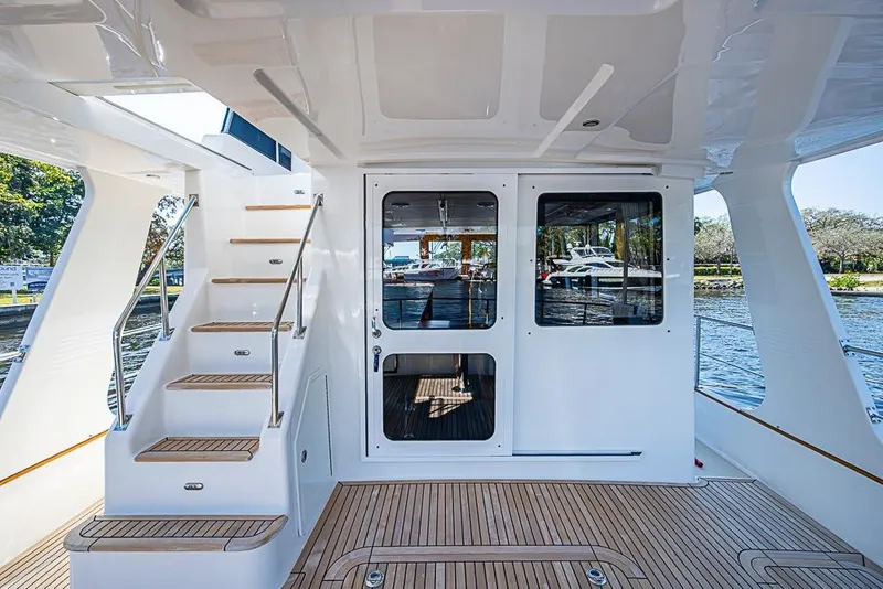 Slide: The Image of Grand Banks 43 Europa 2013 yacht with teak deck and staircase, docked by the water. - 28