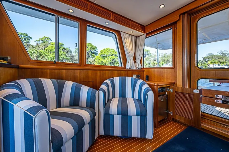 Slide: The Image of Interior of 2013 Grand Banks 43 Europa yacht with striped chairs and wooden accents. - 33