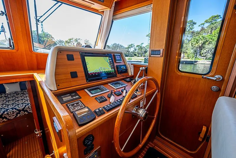 Slide: The Image of Helm of 2013 Grand Banks 43 Europa yacht with navigation equipment and wooden steering wheel. - 4