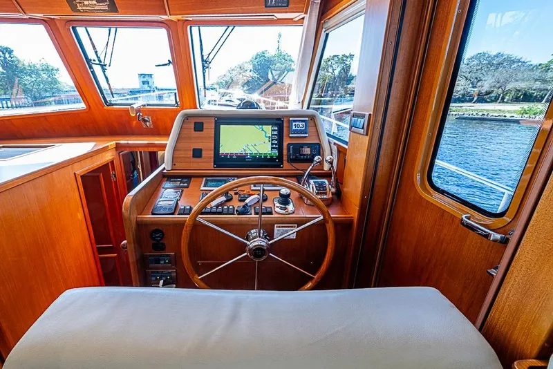Slide: The Image of Helm of 2013 Grand Banks 43 Europa yacht with navigation equipment and wooden steering wheel. - 41