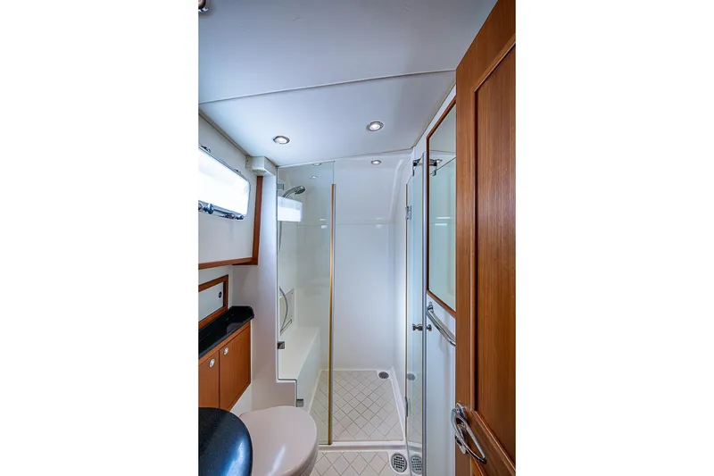 Slide: The Image of Luxurious bathroom in 2013 Grand Banks 43 Europa yacht with modern shower and wooden accents. - 52
