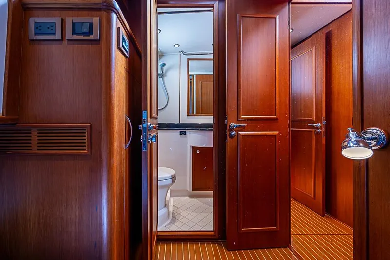 Slide: The Image of Interior of 2013 Grand Banks 43 Europa yacht, featuring wooden cabinetry and bathroom. - 55