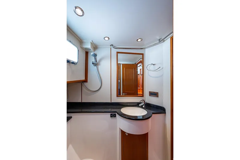 Slide: The Image of Bathroom interior of 2013 Grand Banks 43 Europa yacht, featuring modern fixtures and elegant design. - 59
