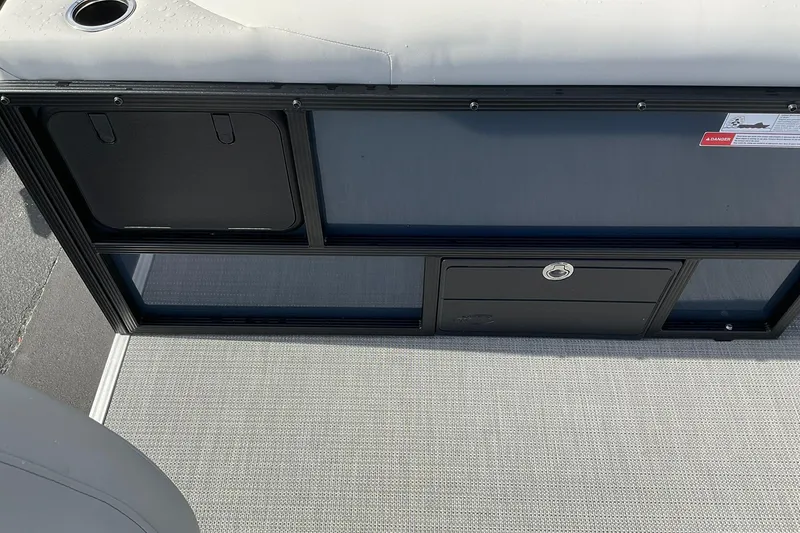 Slide: The Image of 2026 Crest Conquest SE 220 Fish boat interior with storage compartments and cup holder. - 5