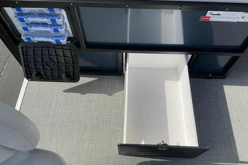 Slide: The Image of Storage compartment of 2026 Crest Conquest SE 220 Fish boat with tackle boxes. - 8