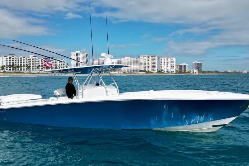 The Image of 2016 Bahama 41 boat cruising near coastal city skyline. - 1