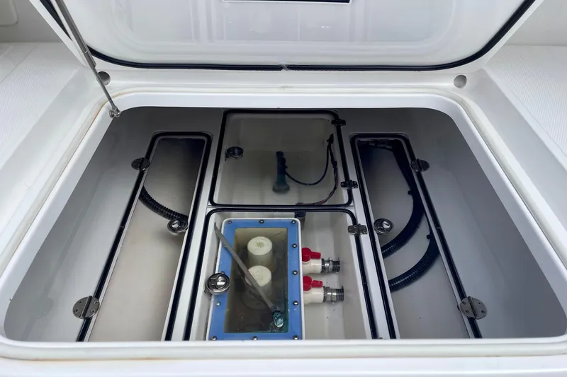 Slide: The Image of Open storage compartment of a 2016 Bahama 41 boat, showcasing internal components. - 13