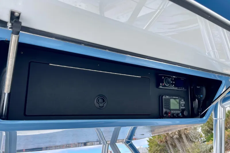 Slide: The Image of 2016 Bahama 41 boat console with electronic controls and storage compartment. - 15