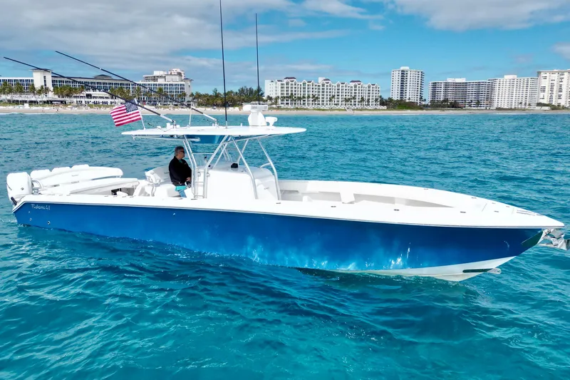 Slide: The Image of 2016 Bahama 41 boat on blue ocean near city skyline, flying American flag. - 3