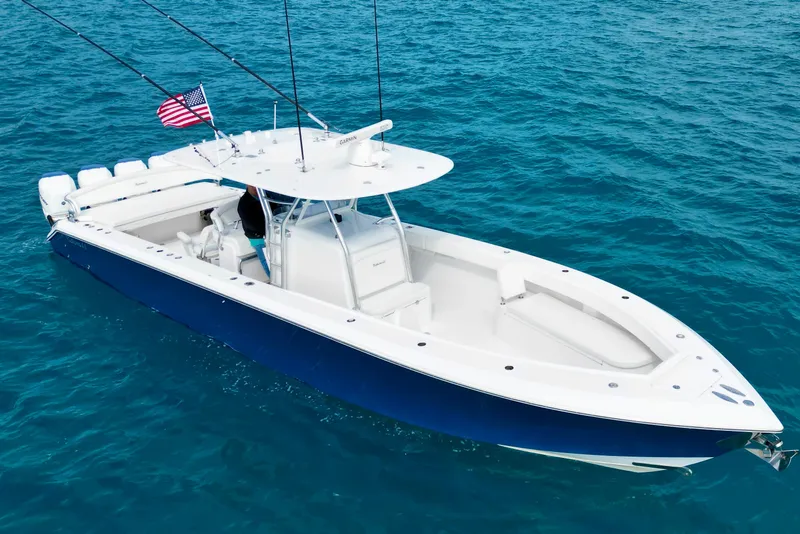 Slide: The Image of 2016 Bahama 41 boat on clear blue ocean water with American flag. - 5