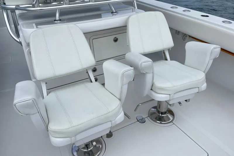 Slide: The Image of White captain chairs on a 2016 Bahama 41 boat deck. - 7