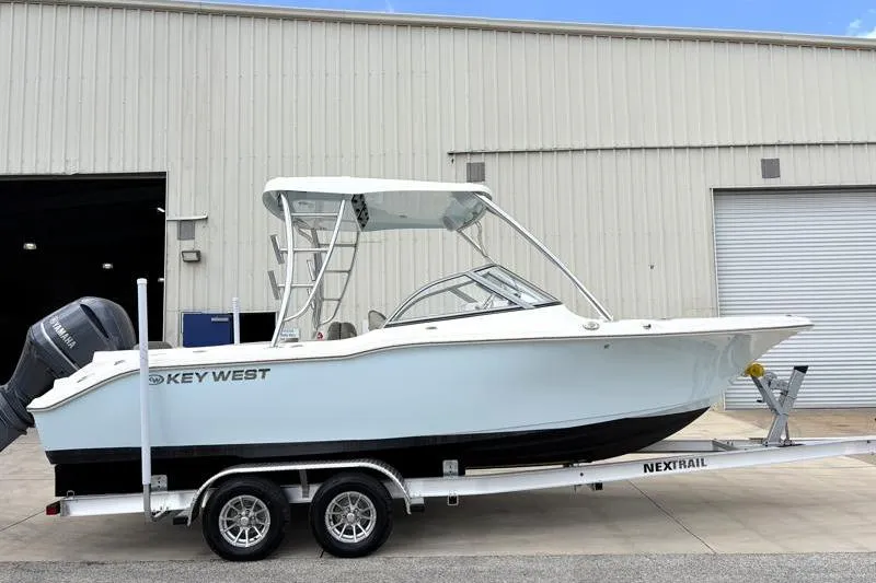 The Image of 2024 Key West 239 DFS boat on trailer outside a warehouse. - 0