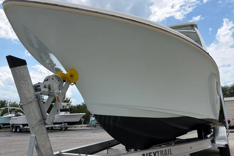 Slide: The Image of 2024 Key West 239 DFS boat on trailer under a cloudy sky. - 10
